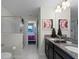 Bathroom with shower, double vanity, and view of bedroom at 9099 Hazard St, Davenport, FL 33896
