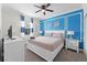Spacious bedroom with a king-size bed and blue accent wall at 9099 Hazard St, Davenport, FL 33896