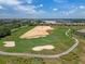 Aerial view of a beautiful golf course with sand traps and greens at 9099 Hazard St, Davenport, FL 33896