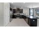 Modern kitchen with dark cabinets, stainless steel appliances and granite countertops at 9099 Hazard St, Davenport, FL 33896