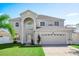Two story home with landscaped lawn and attached garage at 1746 Pompano Dr, Poinciana, FL 34759
