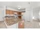 Spacious kitchen with light wood cabinets, granite countertops, and stainless steel appliances at 1746 Pompano Dr, Poinciana, FL 34759