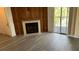 Living room with fireplace, wood accent wall, and sliding glass door to balcony at 3727 Lake Orlando Pkwy # 4, Orlando, FL 32808
