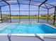 Screened pool with lake view and built-in seating at 4909 Blanche Ct, Saint Cloud, FL 34772