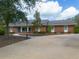 Brick ranch house with a paved driveway at 6365 Whip O Will E Ln, St Cloud, FL 34771