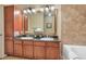 Elegant bathroom with double sinks, granite countertops, and a large mirror at 901 Charo Pkwy # 721, Davenport, FL 33897