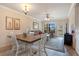 Dining area with a wooden table and white chairs at 901 Charo Pkwy # 721, Davenport, FL 33897