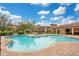 Community pool with surrounding brick patio and seating area at 901 Charo Pkwy # 721, Davenport, FL 33897
