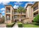 Tan building with balconies and lush landscaping at 901 Charo Pkwy # 721, Davenport, FL 33897