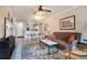 Open living room featuring a brown couch and dining area at 901 Charo Pkwy # 721, Davenport, FL 33897