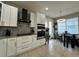 Modern kitchen with white cabinets, stainless steel appliances, and breakfast nook at 2321 Hinsdale Dr, Kissimmee, FL 34741