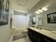 Clean bathroom with granite vanity, tub shower, and updated fixtures at 2321 Hinsdale Dr, Kissimmee, FL 34741