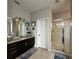 Elegant bathroom featuring dark brown vanity and a walk-in shower at 2321 Hinsdale Dr, Kissimmee, FL 34741
