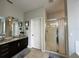 Elegant bathroom featuring dark brown vanity and a walk-in shower at 2321 Hinsdale Dr, Kissimmee, FL 34741