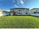 Green grassy backyard, view of home and fence at 2321 Hinsdale Dr, Kissimmee, FL 34741