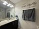 Well-lit bathroom with granite countertop and dark cabinets at 2321 Hinsdale Dr, Kissimmee, FL 34741