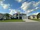 Two-story house with a gray exterior, landscaping, and a two-car garage at 2321 Hinsdale Dr, Kissimmee, FL 34741