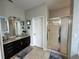 Elegant bathroom featuring dark brown vanity and a walk-in shower at 2321 Hinsdale Dr, Kissimmee, FL 34741