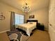 Comfortable bedroom with king bed, window seating, and stylish decor at 2321 Hinsdale Dr, Kissimmee, FL 34741