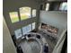 Living room with curved sectional sofa, high ceilings, and kitchen views at 2321 Hinsdale Dr, Kissimmee, FL 34741