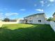 Large backyard with grassy area and white fence at 2321 Hinsdale Dr, Kissimmee, FL 34741