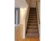 Carpeted staircase leading to the upper level of the home at 1034 Chalcedony St, Kissimmee, FL 34744