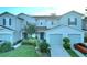 Two-story townhome with attached garage and landscaping at 1034 Chalcedony St, Kissimmee, FL 34744