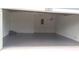 Empty garage with gray epoxy floor and white walls at 106 Sparrow Ct, Kissimmee, FL 34759
