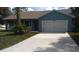 Blue house with white garage door and driveway at 106 Sparrow Ct, Kissimmee, FL 34759