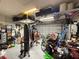 Garage with overhead storage and space for gym equipment at 5652 Arborvista Dr, Saint Cloud, FL 34771