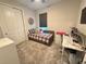 Bright bedroom with a daybed, workspace, and large window at 5652 Arborvista Dr, Saint Cloud, FL 34771