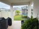 Covered patio overlooking a backyard with trampoline and play area at 5652 Arborvista Dr, Saint Cloud, FL 34771