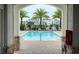 Community pool with lounge chairs and palm trees at 5652 Arborvista Dr, Saint Cloud, FL 34771