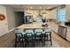 Modern kitchen with white cabinets, large island, and breakfast bar at 5652 Arborvista Dr, Saint Cloud, FL 34771
