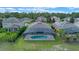 Aerial view of house with pool and screened enclosure, located in a quiet residential neighborhood at 226 Brunswick Dr, Davenport, FL 33837