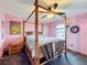 Bedroom with bamboo bed frame and ceiling fan at 4155 Quail Wood Dr, St Cloud, FL 34772