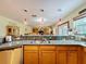 Kitchen boasts a large island with sink and views to Gathering room at 4155 Quail Wood Dr, St Cloud, FL 34772