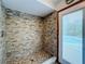 Walk-in shower with tile surround and door to backyard at 4155 Quail Wood Dr, St Cloud, FL 34772