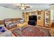Relaxing living room with leather furniture, wood floors and built-in entertainment center at 4155 Quail Wood Dr, St Cloud, FL 34772