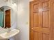 Bathroom with vanity, toilet, and wood door at 4155 Quail Wood Dr, St Cloud, FL 34772