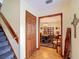 Hallway with wood floors and access to dining room at 4155 Quail Wood Dr, St Cloud, FL 34772