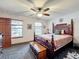 Comfortable bedroom with a wooden bed and large windows at 4155 Quail Wood Dr, St Cloud, FL 34772