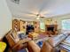 Comfortable living room with a fireplace and large screen TV at 4155 Quail Wood Dr, St Cloud, FL 34772