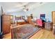 Spacious bedroom with wood floors, a large bed, and ample storage at 4155 Quail Wood Dr, St Cloud, FL 34772