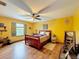 Bedroom with wood flooring, ceiling fan, and window shutters at 4155 Quail Wood Dr, St Cloud, FL 34772
