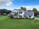 Two-story house with white siding, grey roof, and a large green lawn at 4155 Quail Wood Dr, St Cloud, FL 34772