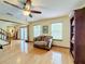 Bright living room with hardwood floors, a ceiling fan, and access to backyard at 4155 Quail Wood Dr, St Cloud, FL 34772