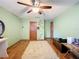 Spacious bedroom with wood floors, ceiling fan, and double door closets at 4155 Quail Wood Dr, St Cloud, FL 34772
