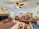 Open living room with a fireplace, leather furniture and view to kitchen at 4155 Quail Wood Dr, St Cloud, FL 34772