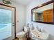 Bathroom with toilet, sink, and a large mirror at 4155 Quail Wood Dr, St Cloud, FL 34772